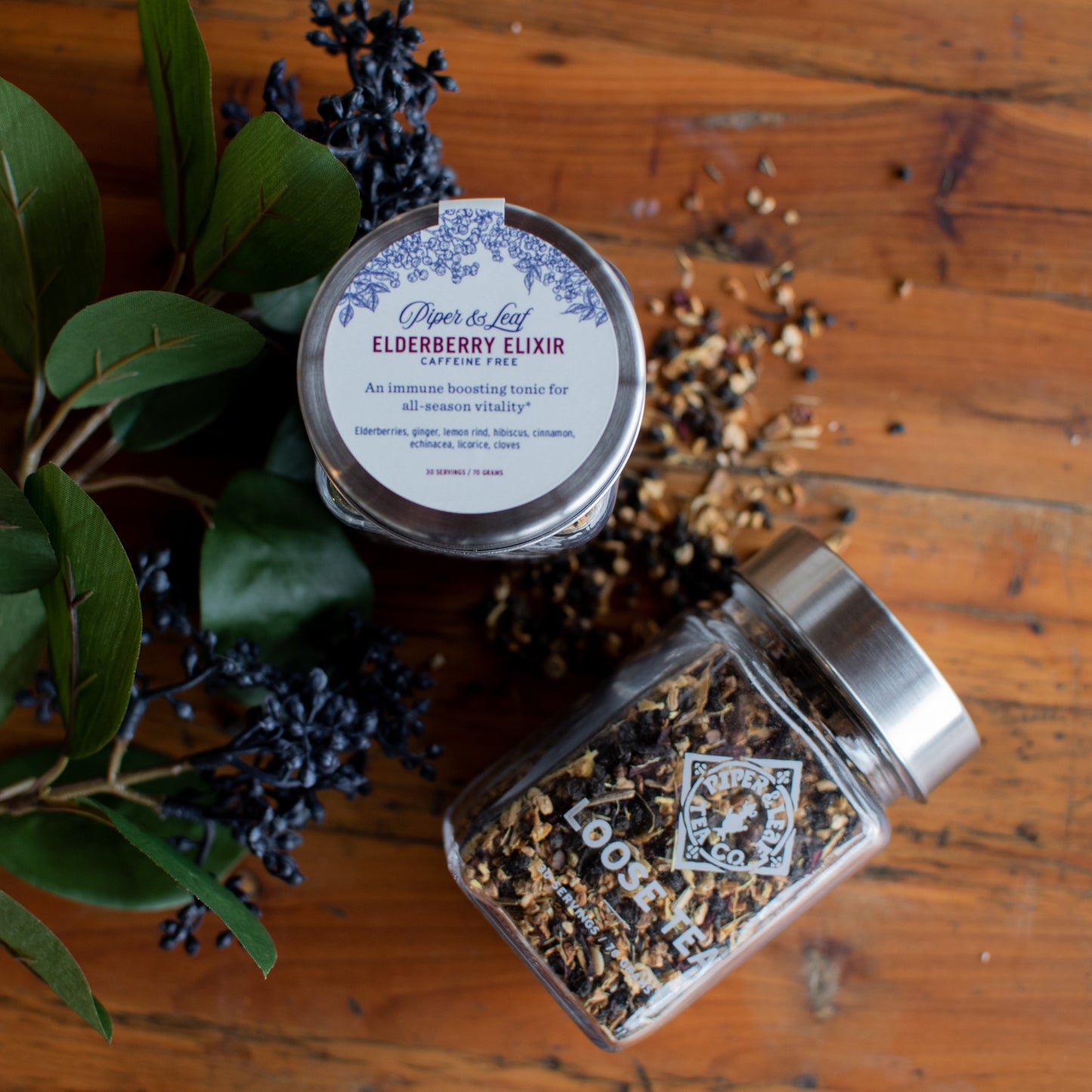 Glass jar of Elderberry Elixir loose leaf tea by Piper and Leaf Tea Co., showing dried elderberries and tea leaves inside.
