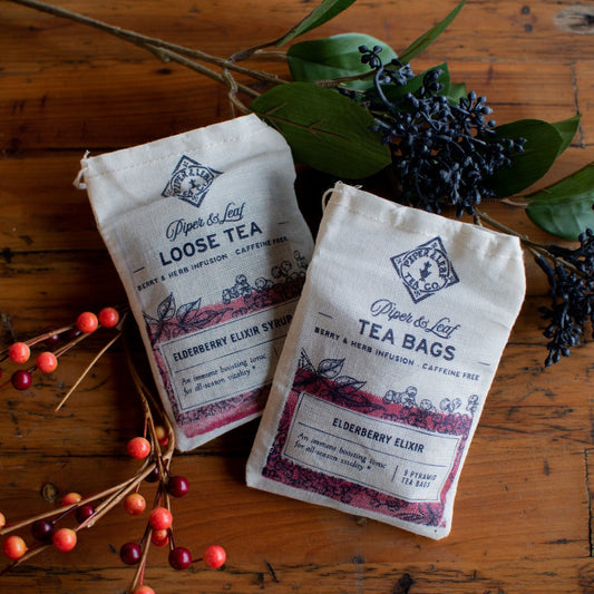 Piper and Leaf Elderberry Elixir Loose Leaf Tea in a clear jar, showing dark dried elderberry leaves and herbs for 15 servings.