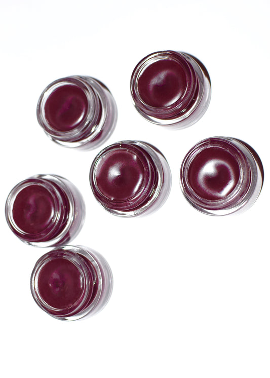 Hibiscus and beet lip tint by Plant Makeup displayed on a neutral background, showcasing the vibrant natural lip color.