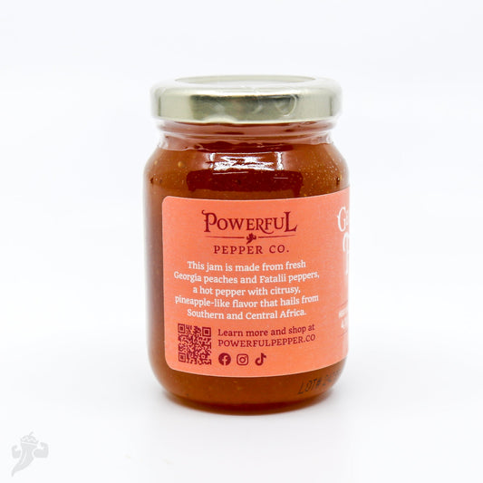 Peach Fatalii Jam by Powerful Pepper Company in a jar, showcasing fresh peaches and vibrant jam color.