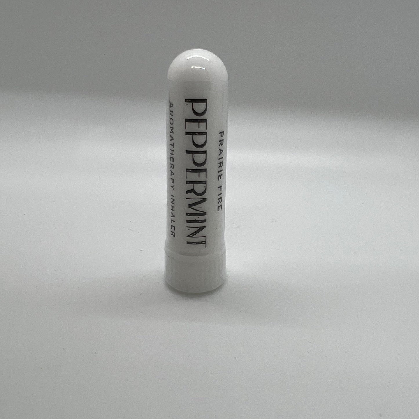 Peppermint aromatherapy inhaler from Prairie Fire Tallow featuring a sleek portable container for refreshing mint scent.