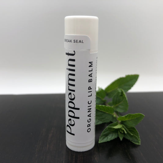 Peppermint lip balm stick from Prairie Fire Tallow featuring a sleek silver packaging and a peppermint flavor label.