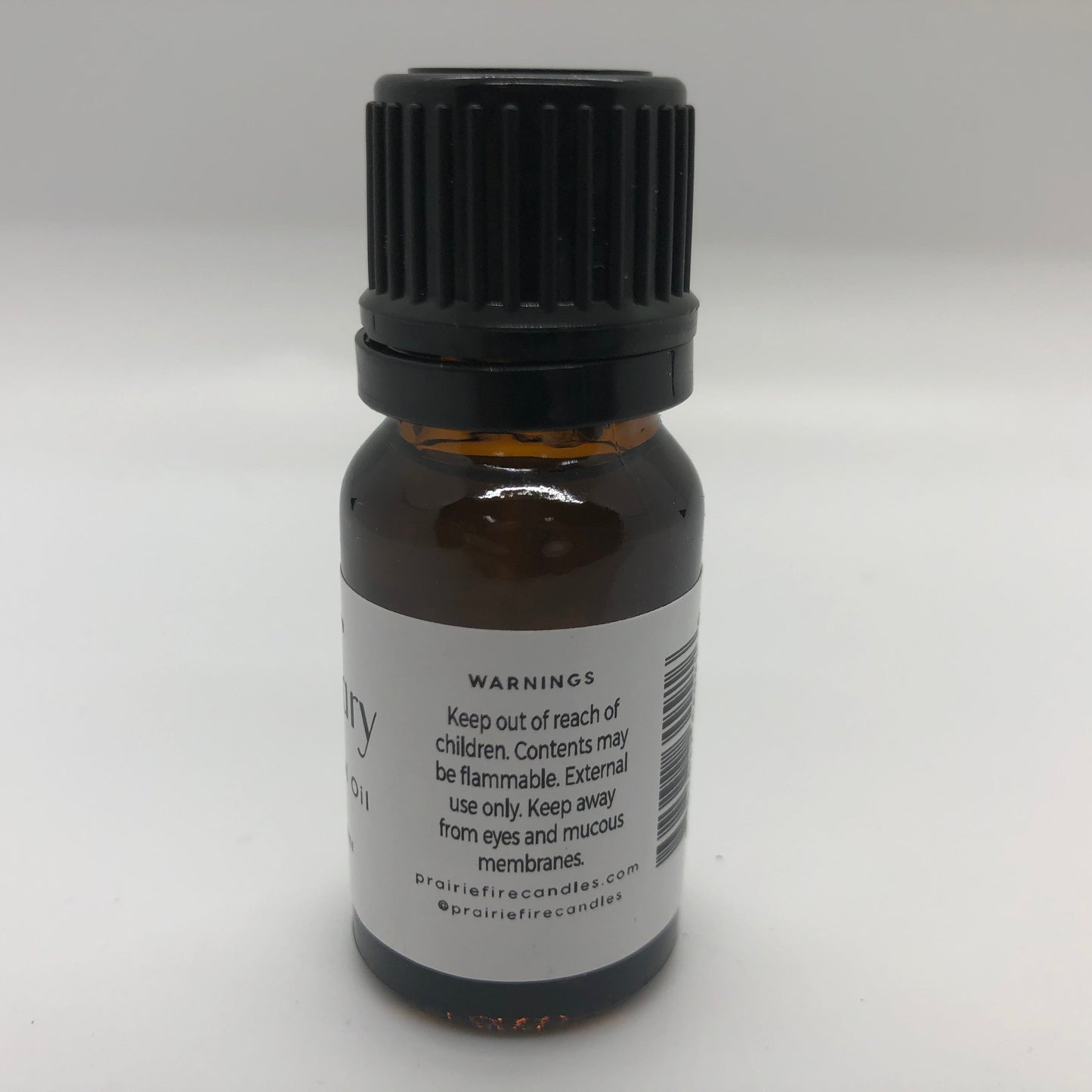 Bottle of Prairie Fire Rosemary Essential Oil, 10 ml (0.35 oz), showing the label and amber glass dropper bottle.