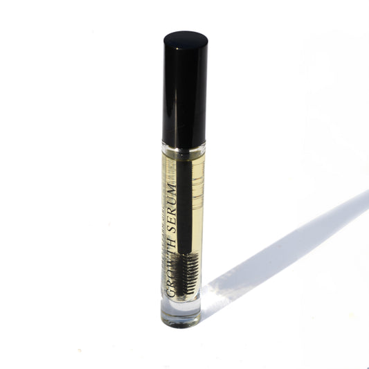 Pretty Farm Girl eyelash and eyebrow growth serum bottle, showcasing the eyelash serum product for enhanced lash and brow growth.