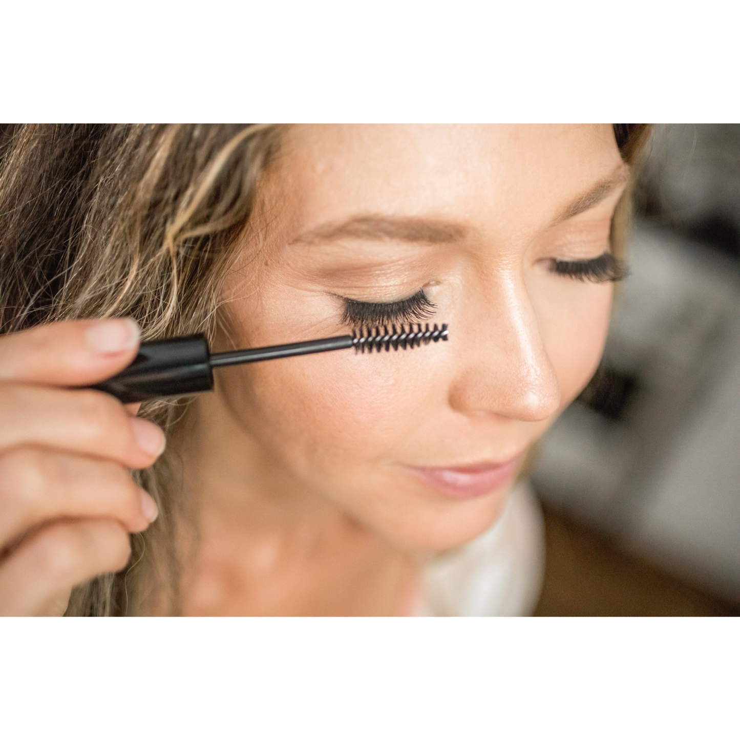 Pretty Farm Girl eyelash and eyebrow growth serum bottle, showcasing the product used for enhancing lash and brow length.