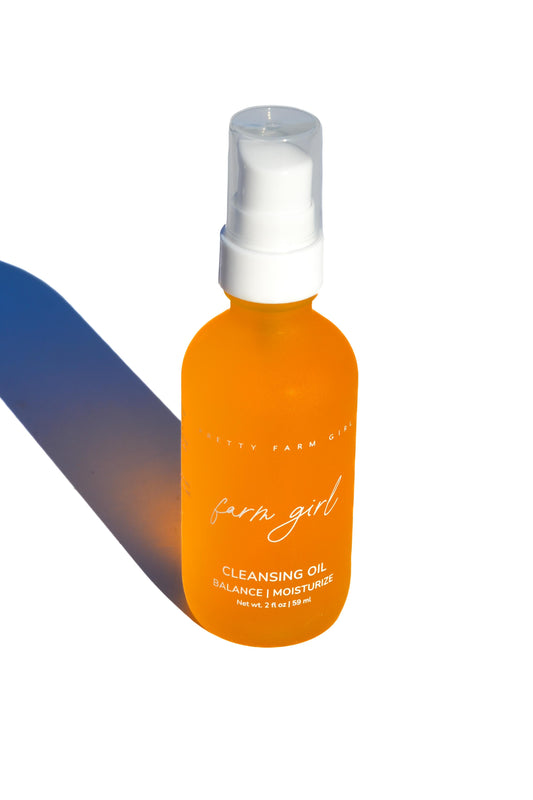 Pretty Farm Girl Cleansing Oil face cleanser in a 2 oz bottle, with natural ingredients and gentle cleansing properties.