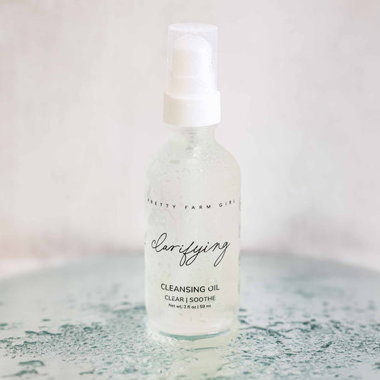 Pretty Farm Girl Clarifying Cleansing Oil for acne-prone skin, face cleanser with natural ingredients, in a clear bottle.