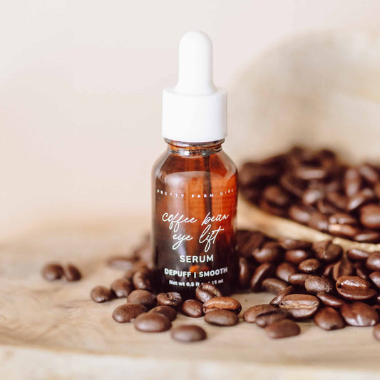 Pretty Farm Girl Coffee Bean Eye Lift Serum in a sleek face serum bottle, designed to reduce puffiness and brighten the eye area.