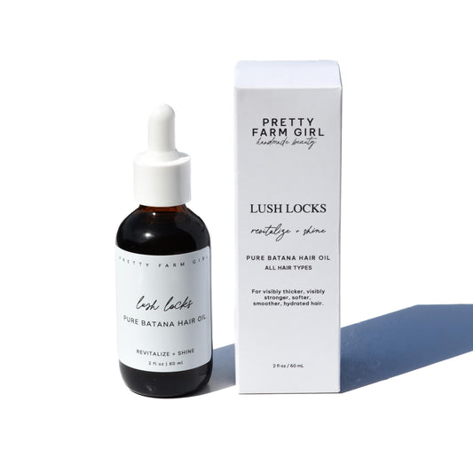Pretty Farm Girl Lush Locks Batana Hair Oil in a bottle, natural hair care product for shiny, healthy hair.