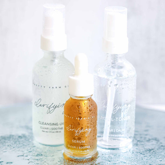 Pretty Farm Girl clarifying kit for acne-prone skin featuring skincare bottles and applicators for clear, healthy skin.