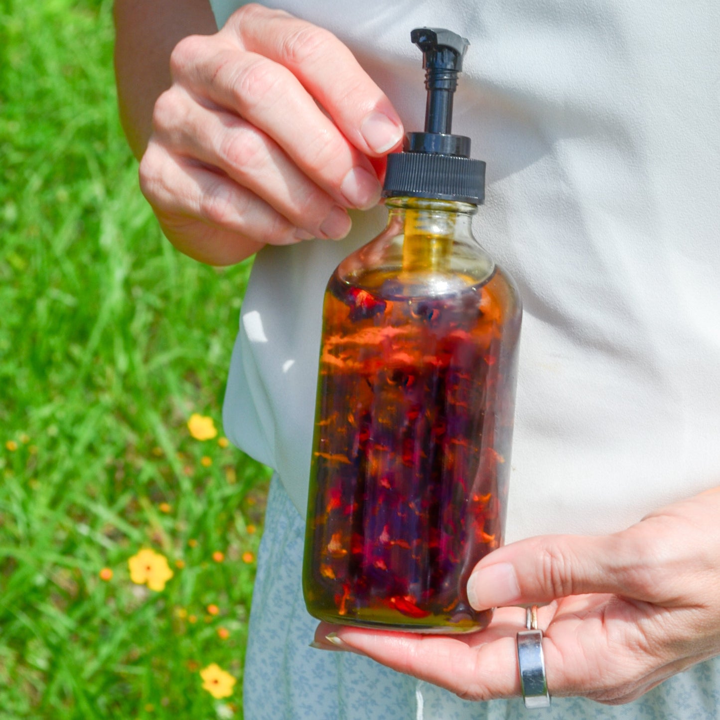 Pretty Farm Girl Lymph Love Natural Body Oil for lymphatic massages, featuring a sleek bottle with herbal ingredients.