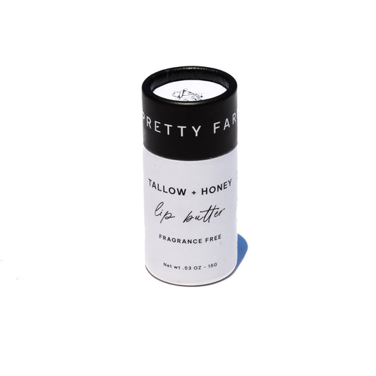 Fragrance-free tallow and honey lip butter in eco-friendly travel tube, natural ingredients, creamy texture, and minimalist design.
