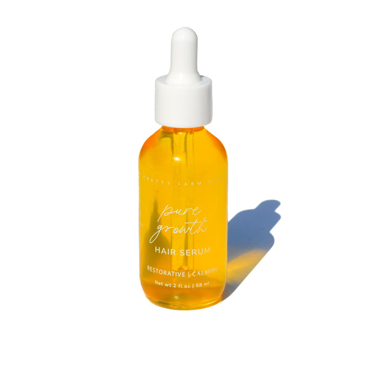Pretty Farm Girl Pure Growth Hair Serum, scalp and hair oil, in a clear bottle with a pump dispenser.