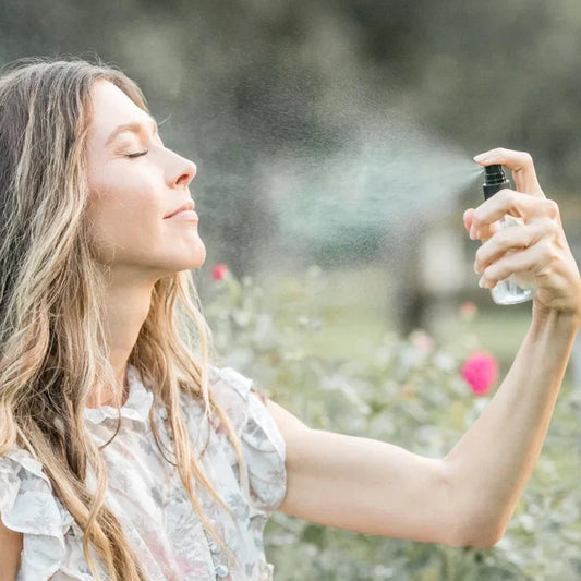 Organic Pure Rose Facial Toner by Pretty Farm Girl in a 2 oz bottle, showing a clear glass bottle with a rose-colored liquid and floral label.