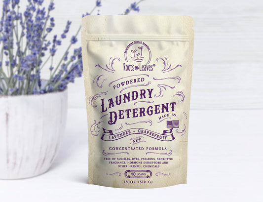 Powdered laundry detergent by Roots and Leaves LLC in a white container with a clean label, ideal for stain removal and fresh laundry.