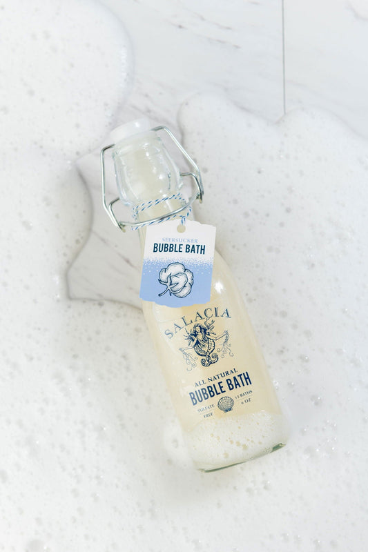 Salacia Salts Seersucker Bubble Bath in a clear bottle with a pump dispenser, creamy foam and soothing lavender scent.