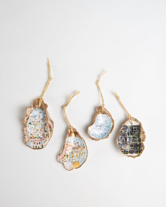 Salacia Salts souvenir ornaments made from oyster shells featuring a Savannah downtown city map design.