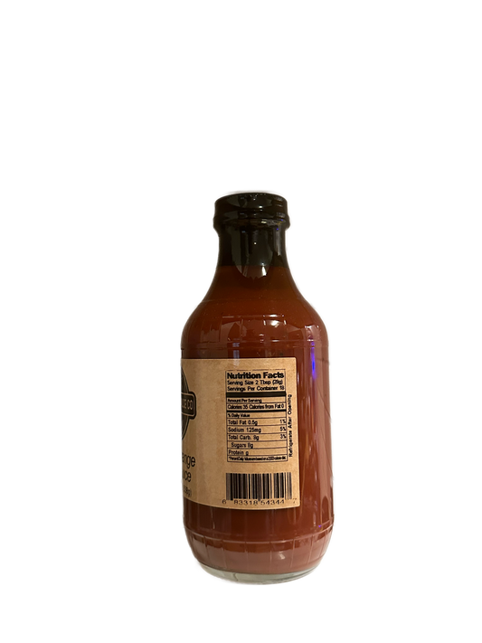 A glass bottle of SavannahSauceCompany’s NEW Tangy Orange BBQ Sauce Case features a black cap, nutrition facts and barcode on the label. The dark reddish-brown sauce hints at its Jacksonville Florida oranges blend. Displayed against a plain background.