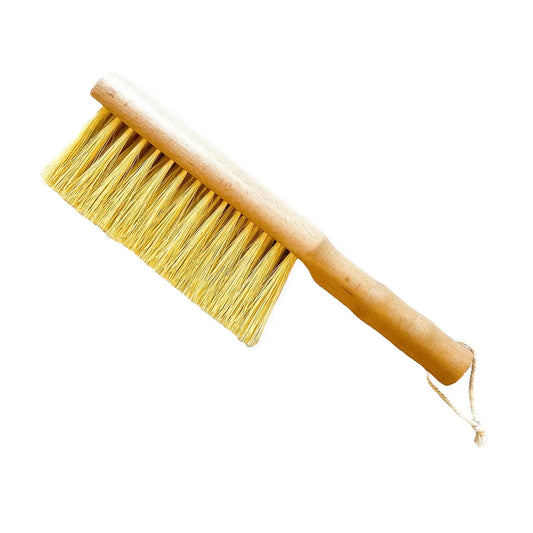 Multi-purpose gardener's brush by Seattle Seed Company with sturdy bristles for cleaning gardening tools and soil.