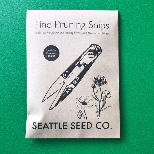 Close-up of Seattle Seed Company Precision Herb Snips with stainless steel blades for precise herb trimming.