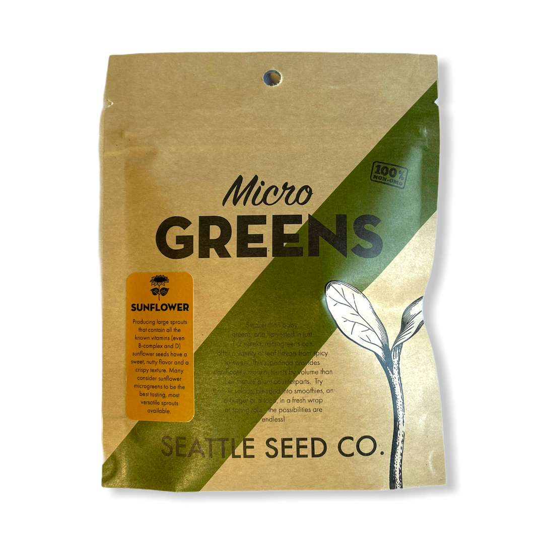 Bright sunflower microgreens from Seattle Seed Company displayed in a container, showcasing vibrant green leaves and delicate stems.