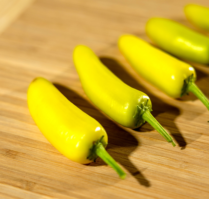 Packet of Seeds 'n Such Hungarian Yellow Hot Wax Pepper Seeds showing bright yellow pepper seeds in a packet.