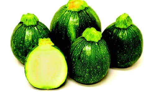Packet of Eight Ball Hybrid Zucchini Squash Seeds by Seeds 'n Such showing vibrant seed packet with seeds inside
