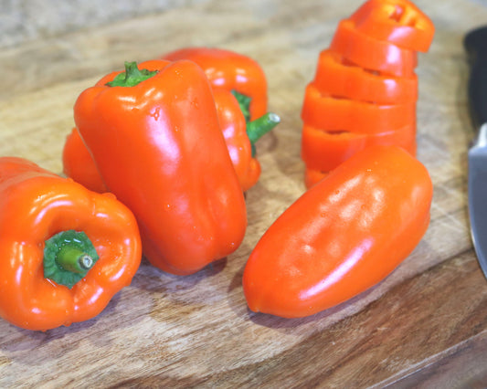 Orange Blaze hybrid pepper seeds packet from Seeds 'n Such showing 8 to 10 orange pepper seeds in a clear packet.