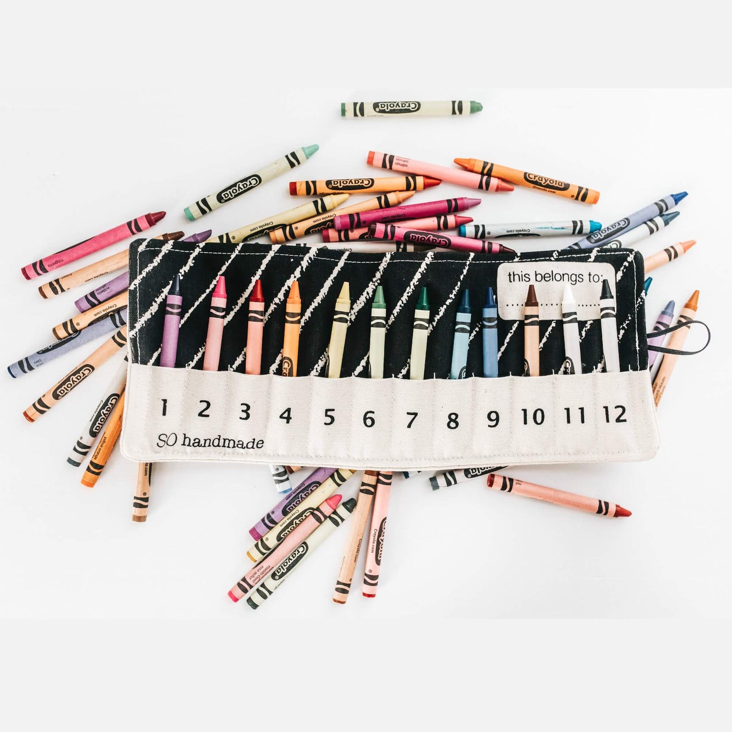 Portable crayon holder by So Handmade Shop, perfect for travel, featuring colorful crayons inside a compact, convenient coloring accessory.