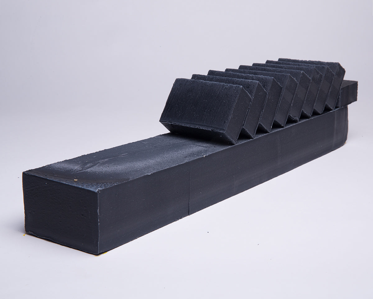 Bar of Soap for Sinners with bamboo charcoal and cedarwood, showcasing the natural soap bar with textured surface and earthy tones.