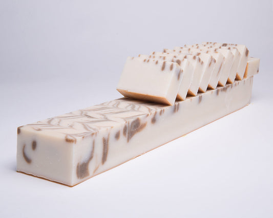 Bar of Soap for Sinners Spearmint with Rosemary soap showing a rectangular bar with green spearmint and rosemary herbs.