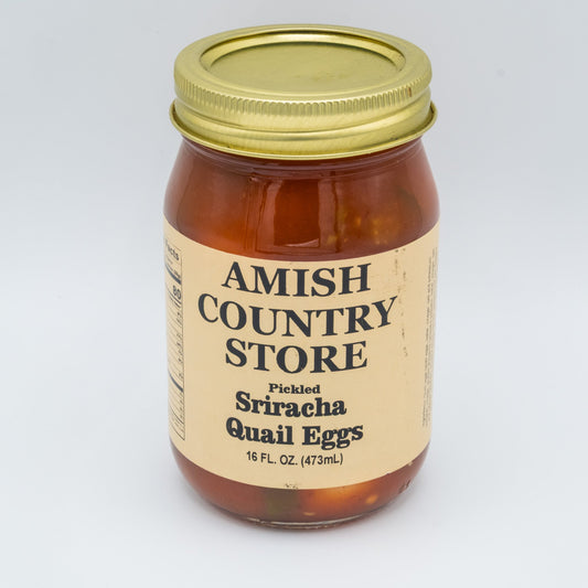 Canned Pickled Sriracha Quail Eggs by Amish Country Store, showing vibrant eggs submerged in spicy Sriracha pickling brine