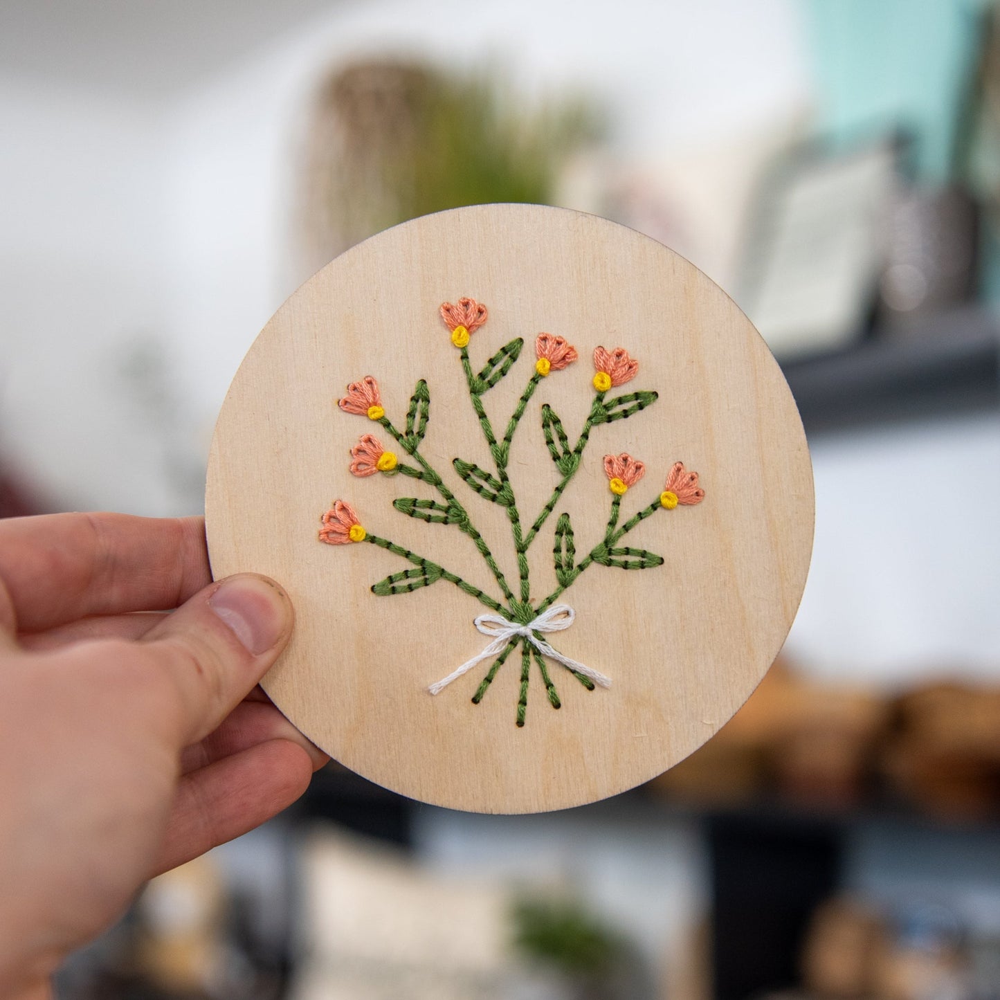 Still Magnolia Peonie Bouquet Embroidery Kit featuring colorful embroidery floss and fabric for floral needlework.