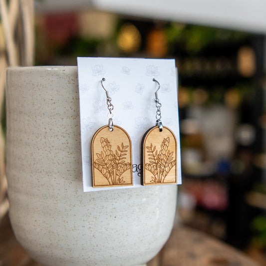 Still Magnolia ZZ Plant arched earrings featuring delicate green leaf design, lightweight jewelry for everyday wear.