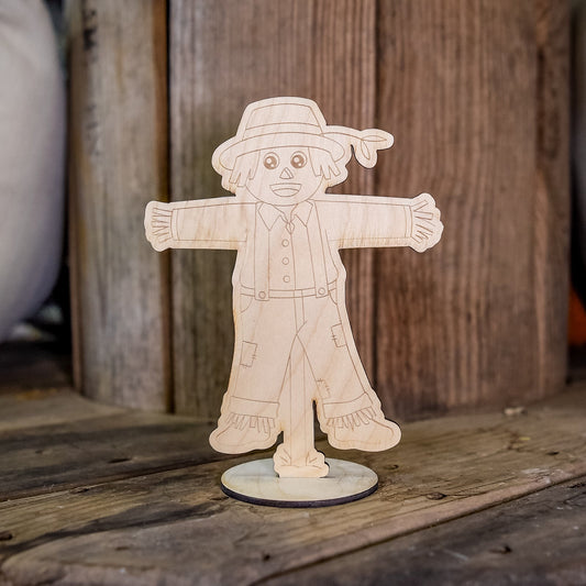 Kids painting kit featuring a fall scarecrow craft by Still Magnolia, includes colorful materials for creative autumn art projects.