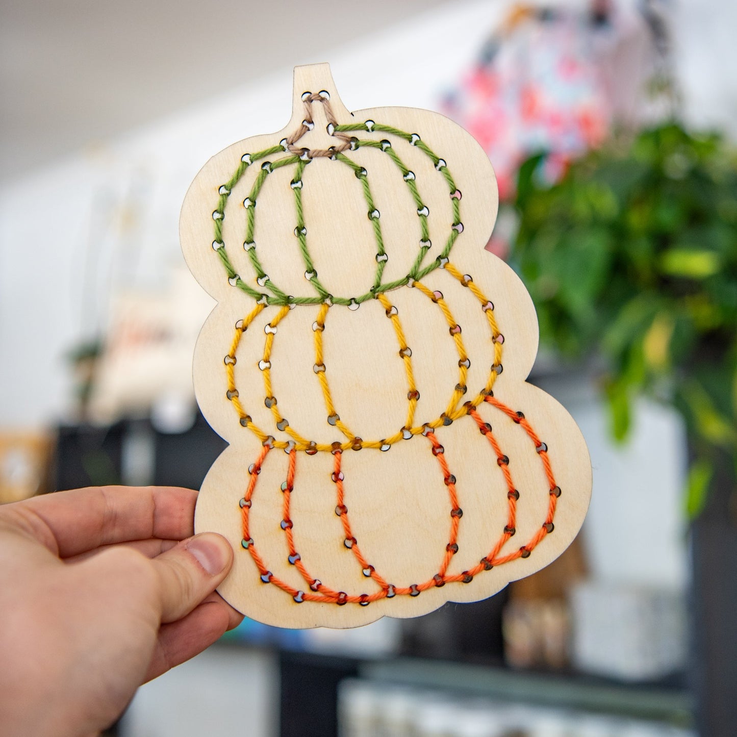 Still Magnolia pumpkin yarn embroidery kit with colorful threads and fabric for creating festive pumpkin embroidery art.