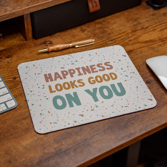 Still Magnolia happiness-themed mouse pad with uplifting "Happiness Looks Good on You" design, perfect for desk use.