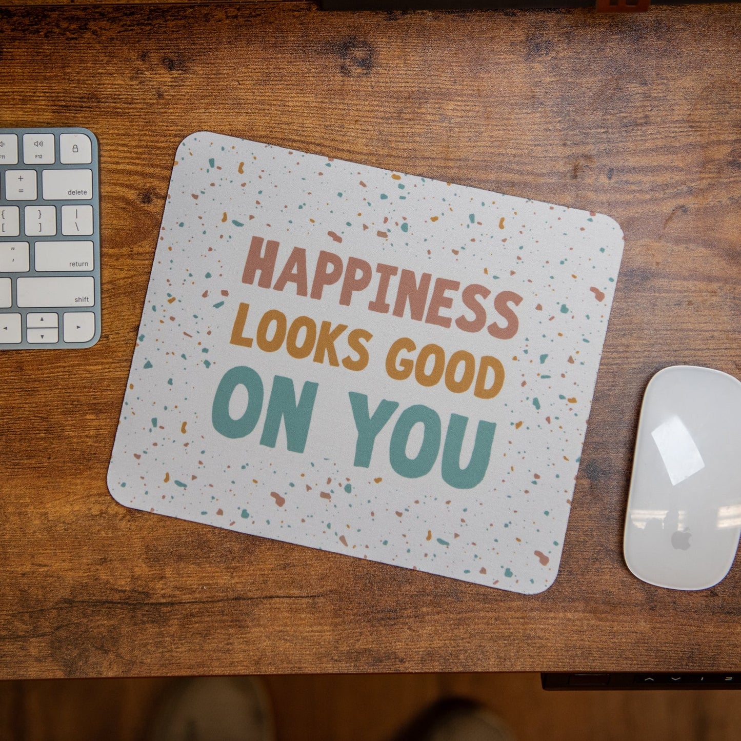 Still Magnolia mouse pad featuring the inspirational quote "Happiness Looks Good on You" with a vibrant design.
