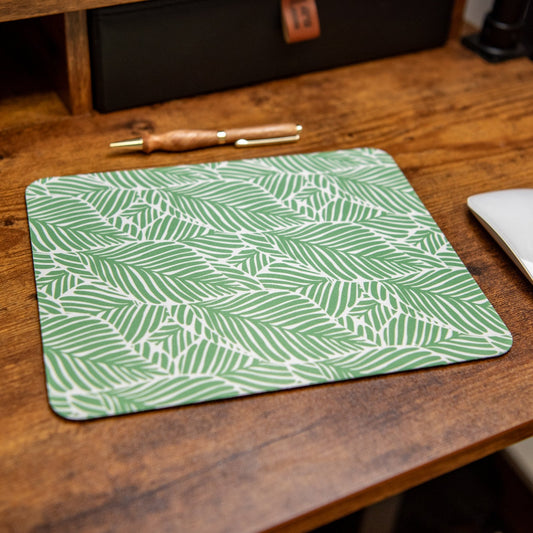 Leafy Luxe Still Magnolia mouse pad featuring a vibrant leafy design on a smooth surface for comfortable use.