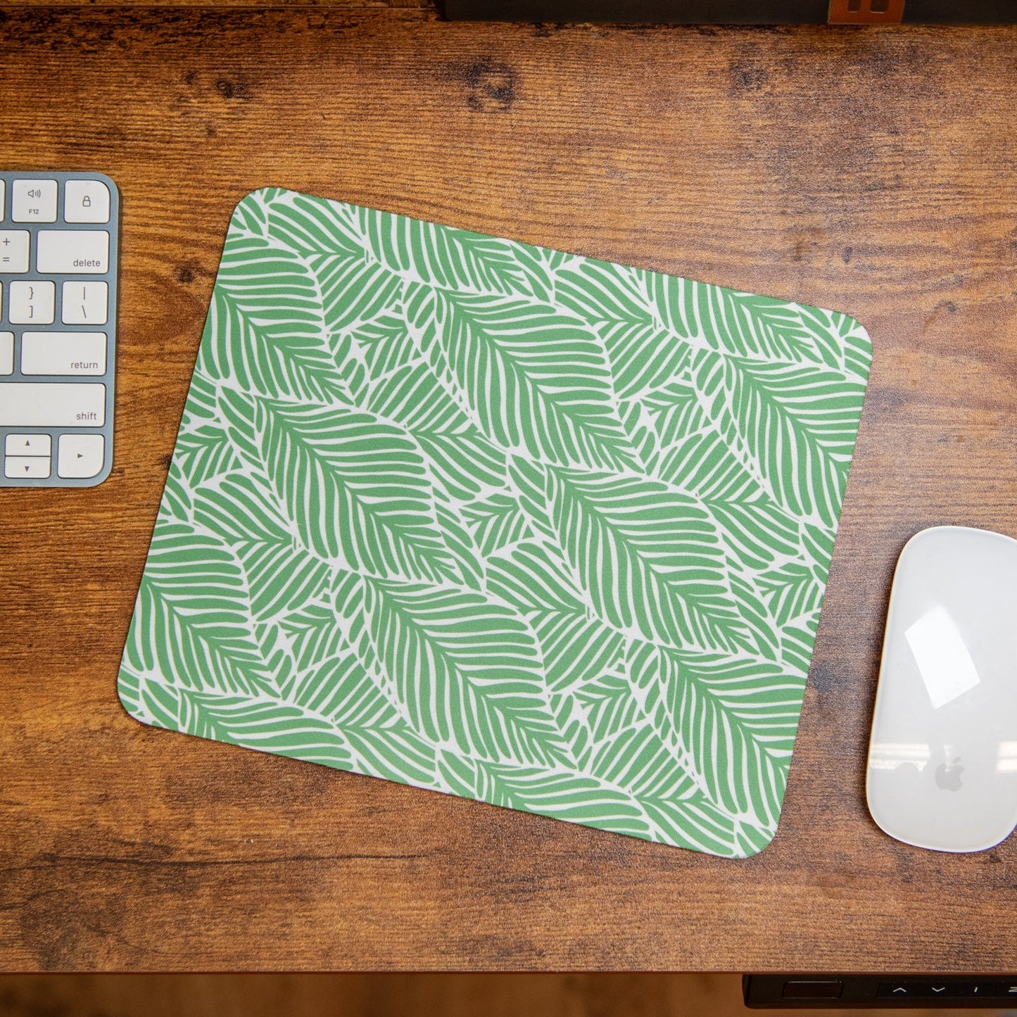 Still Magnolia Leafy Luxe mouse pad with vibrant leafy design, providing a stylish and smooth surface for computer use.