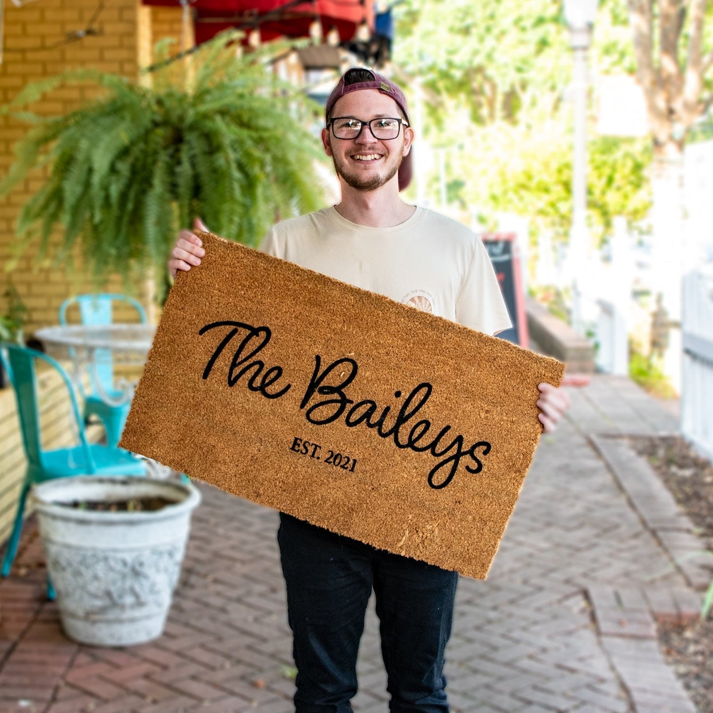 Personalized Still Magnolia family name doormat with custom text, featuring a welcoming design for home entrance.