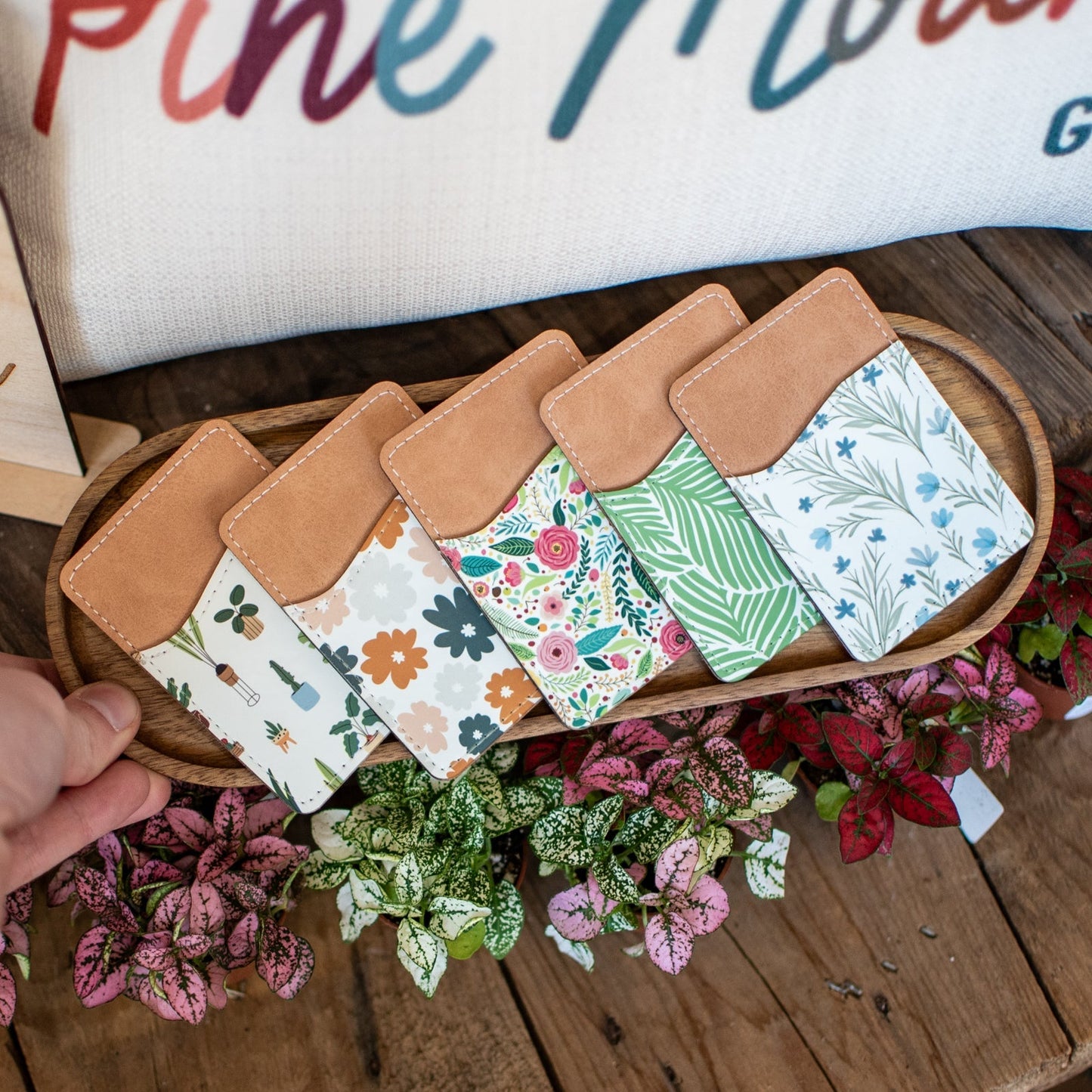 Still Magnolia phone wallet featuring "Books Are My First Love" design, with card slots and a secure closure for phone and essentials.