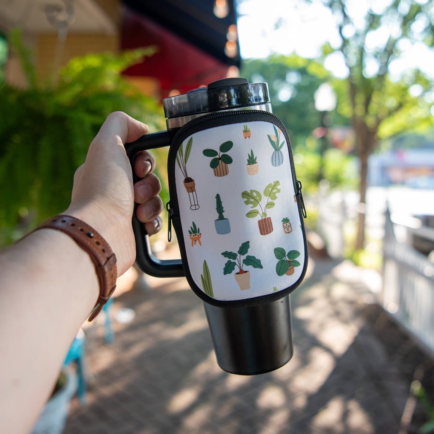 Still Magnolia houseplant tumbler pouch with a vibrant, leafy plant design for keeping your tumbler protected and stylish.