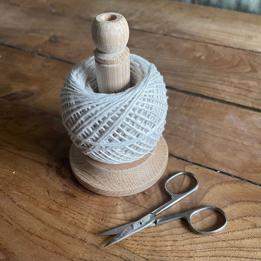 Oak string tidy with scissors and baker's twine from The Celtic Farm, neatly arranged on a rustic surface.