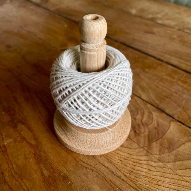 Oak string tidy with scissors and baker's twine from The Celtic Farm, neatly arranged on a wooden surface.