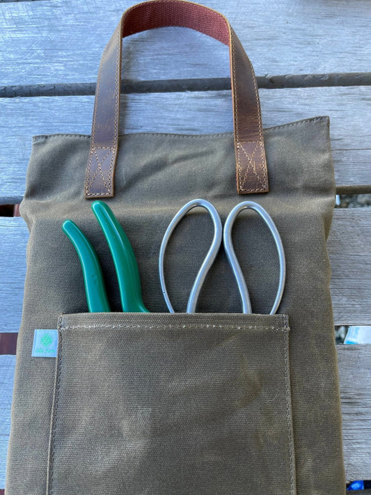 Waxed canvas garden kneeler pad by The Celtic Farm, providing comfortable cushioning for gardening tasks.