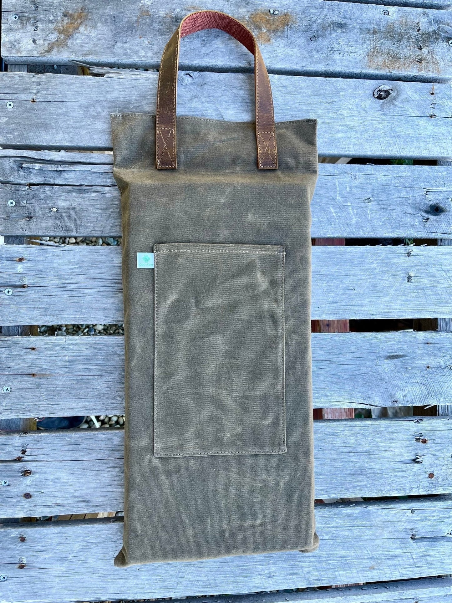 Waxed canvas garden kneeler pad by The Celtic Farm, providing comfortable cushioning for gardening tasks.