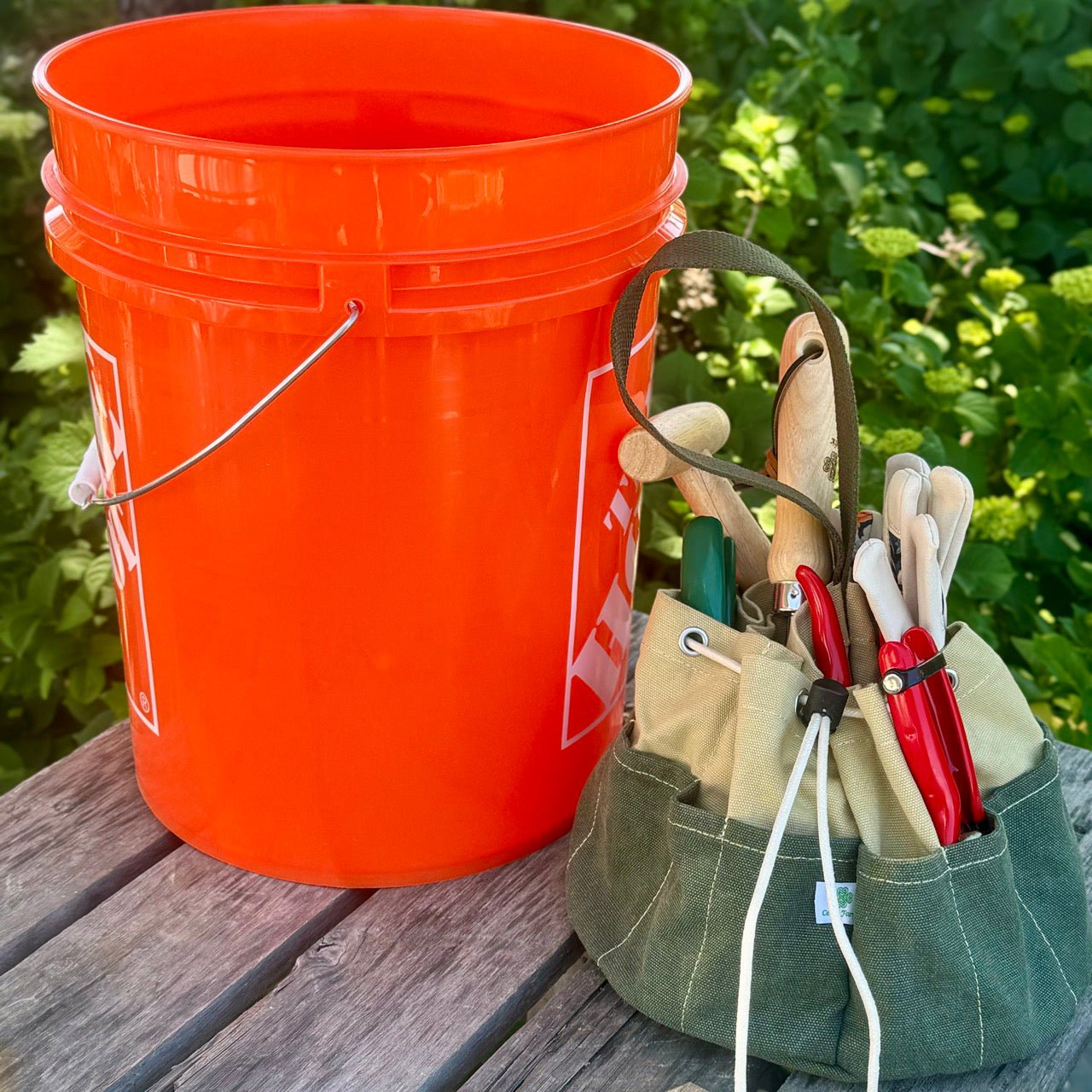 Heavy waxed canvas garden bucket bag from The Celtic Farm, a durable gardening tote with sturdy handles for outdoor use.