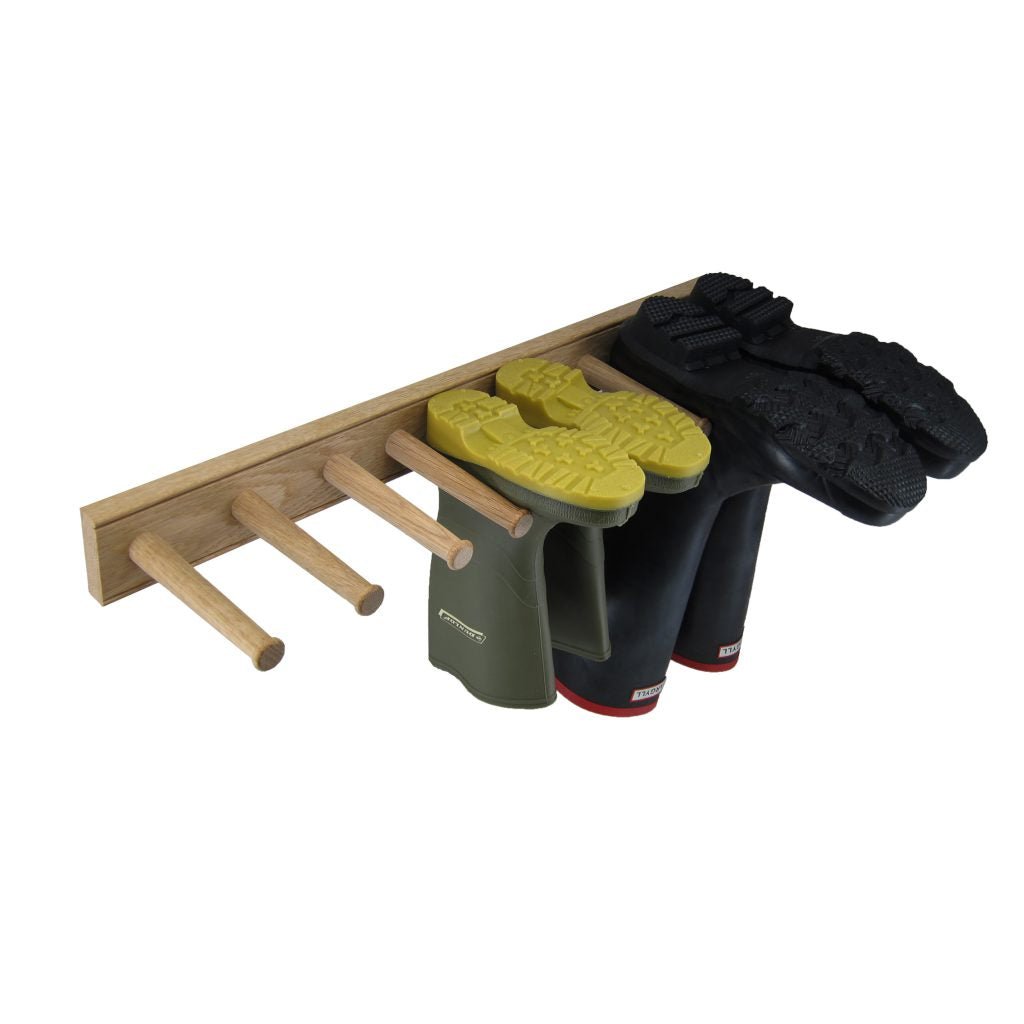 White Oak English Wellington Boot Rack by The Celtic Farm holding three pairs of wellington boots in a home setting.