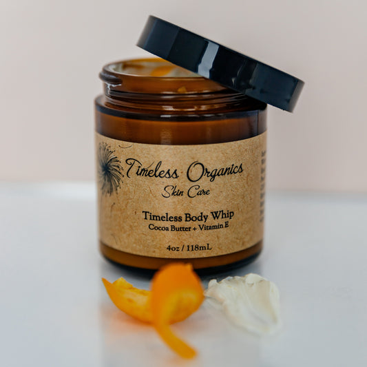 Creamy cocoa butter and vitamin E body whip lotion by Timeless Organics Skin Care, smooth and nourishing skincare product.